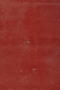 a close up of a red wall with a clock on it